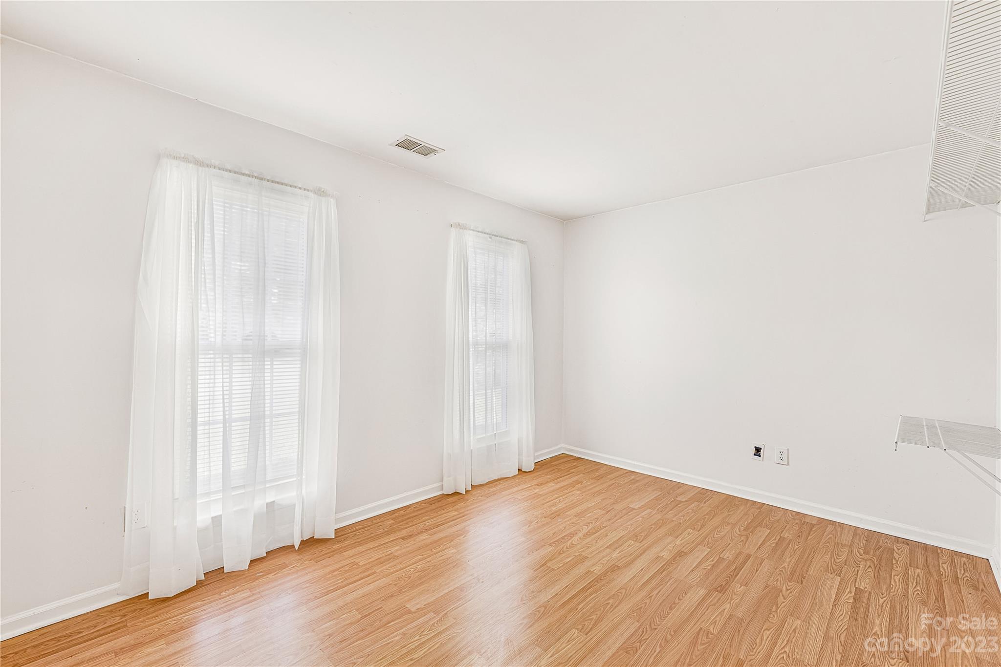 9504 Foggy Meadow Road Charlotte, NC 28269 - Photo 15 of 24 a view of empty room with wooden floor