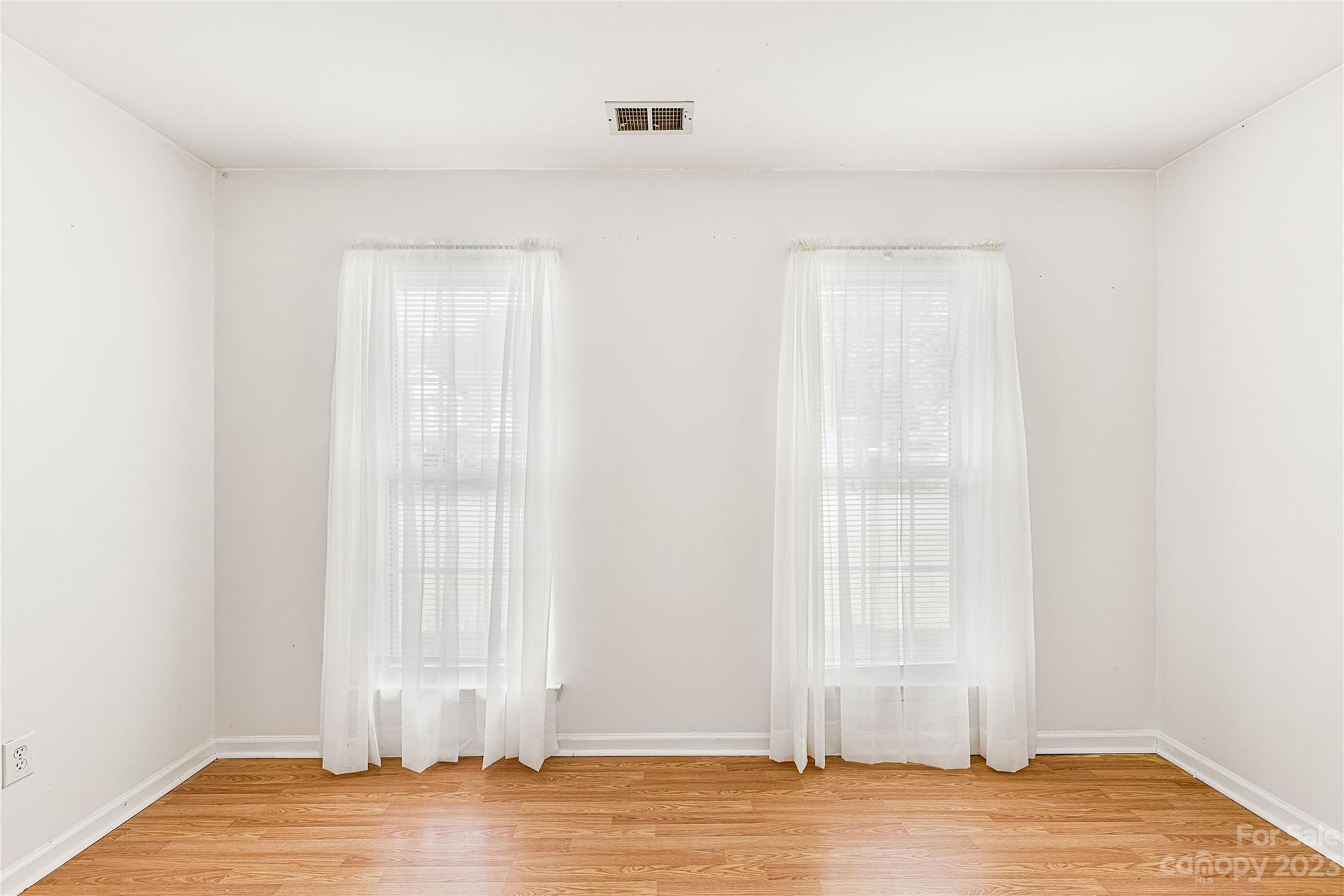 9504 Foggy Meadow Road Charlotte, NC 28269 - Photo 16 of 24 a view of empty room with wooden floor and fan