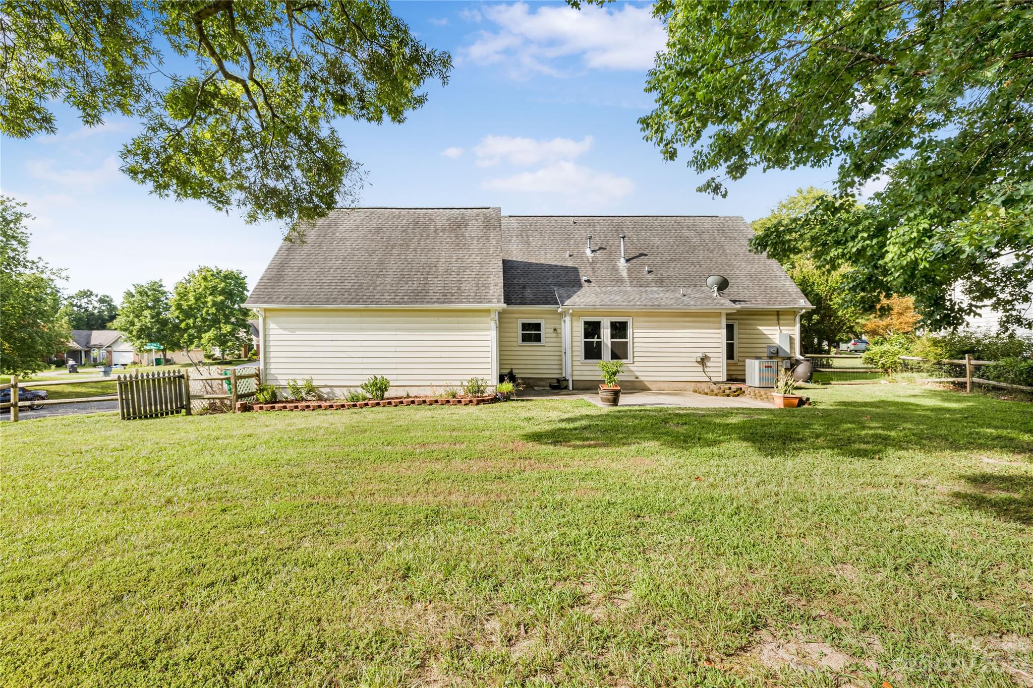 9504 Foggy Meadow Road Charlotte, NC 28269 - Photo 22 of 24 a front view of house with yard and trees