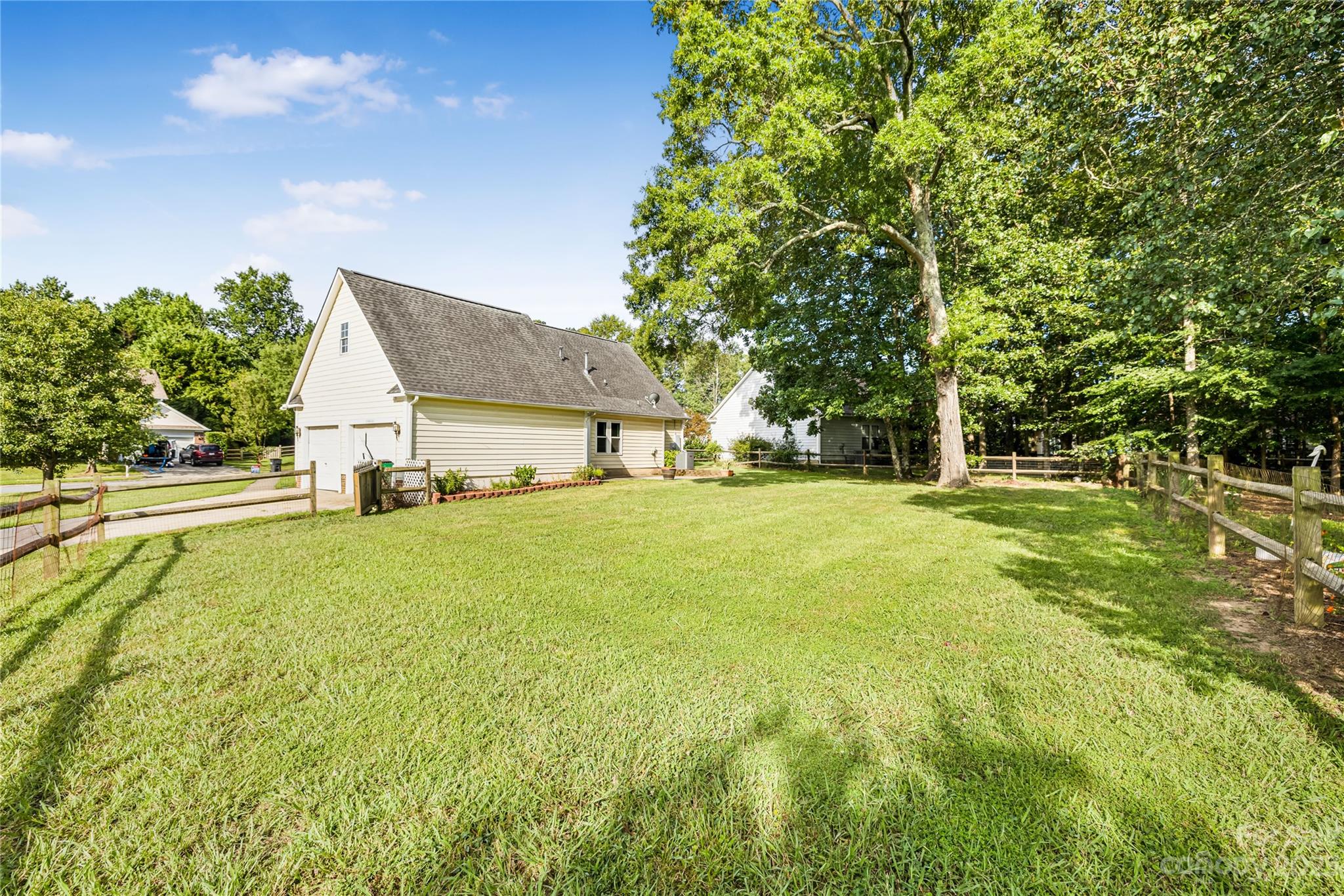 9504 Foggy Meadow Road Charlotte, NC 28269 - Photo 23 of 24 a view of an house with backyard space and garden
