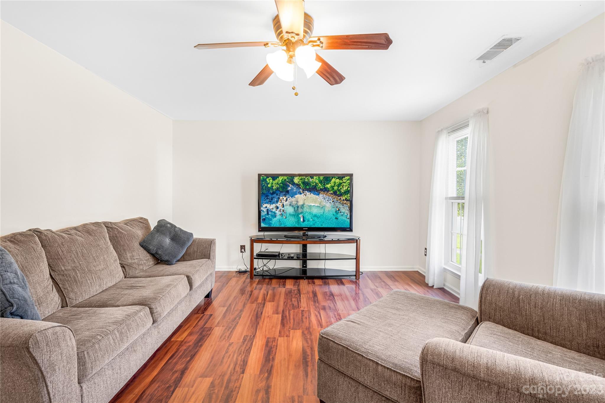 9504 Foggy Meadow Road Charlotte, NC 28269 - Photo 4 of 24 a living room with furniture and a flat screen tv