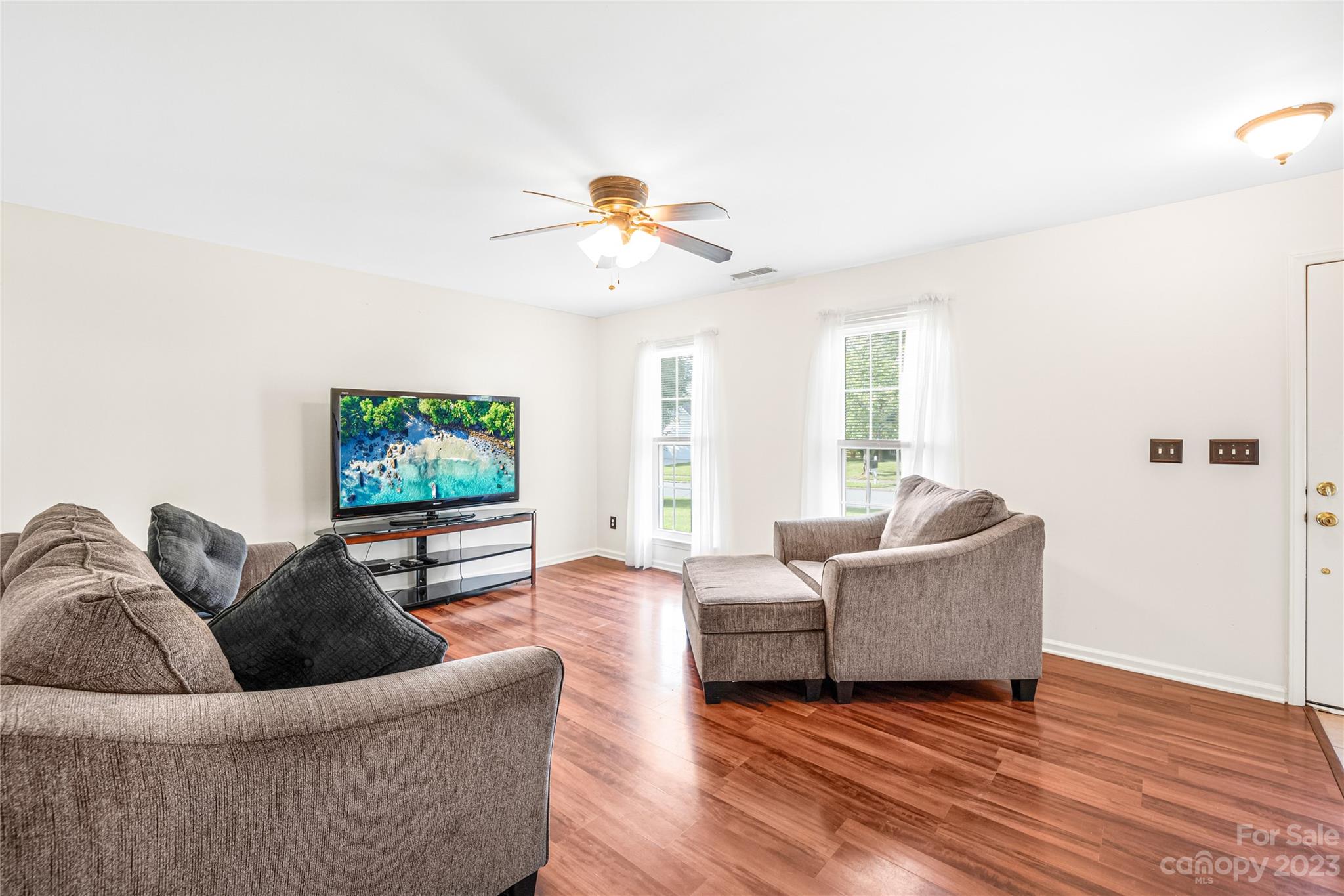 9504 Foggy Meadow Road Charlotte, NC 28269 - Photo 5 of 24 a living room with furniture and a flat screen tv