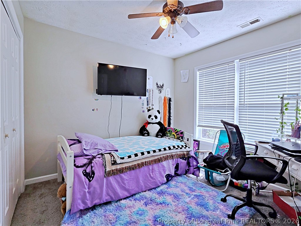 5218 Pringle Way Hope Mills, NC 28348 - Photo 31 of 43 a bedroom with a bed a desk and chair