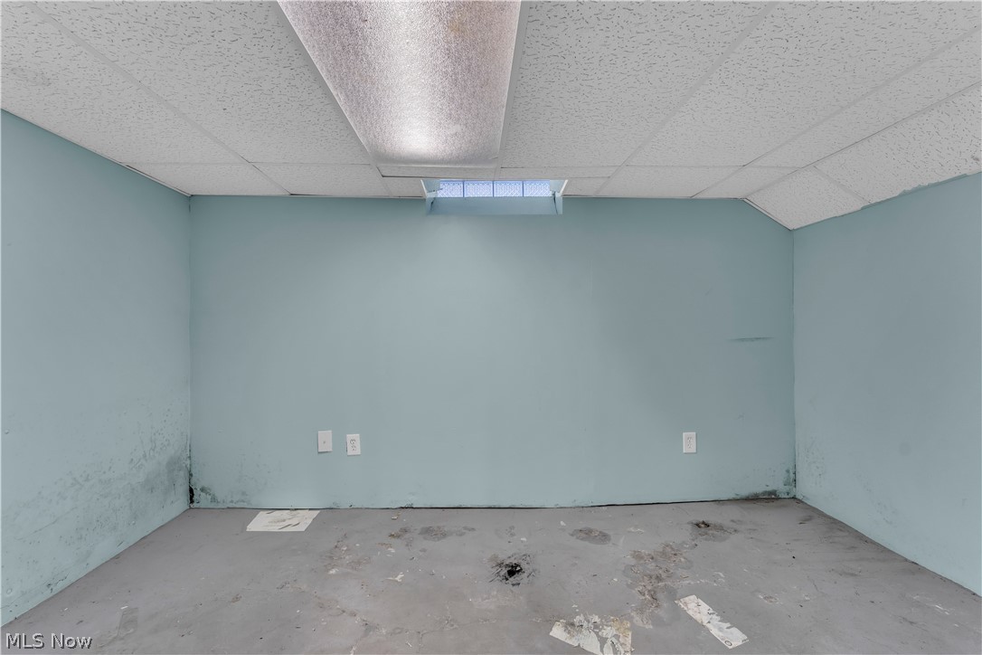 1858 Rudwick Road Cleveland, OH 44112 - Photo 31 of 36 Unfurnished room with a paneled ceiling and concrete floors