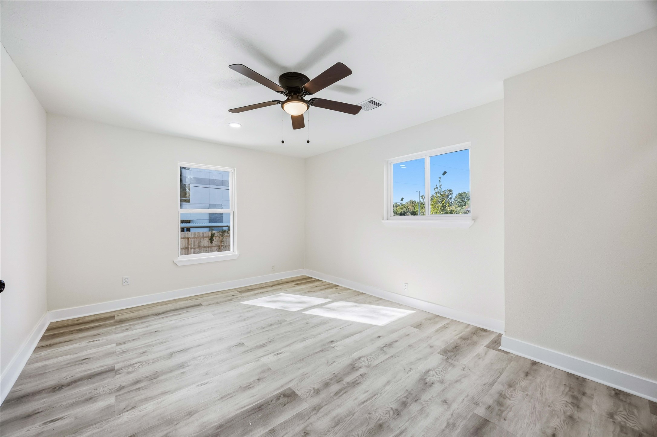 18234 Atkinson Lane Conroe, TX 77384 - Photo 19 of 30 a view of an empty room with a window and wooden floor