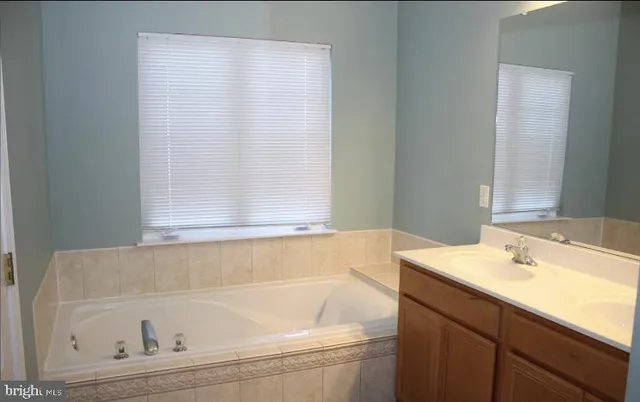 a bathroom with a bathtub and a sink