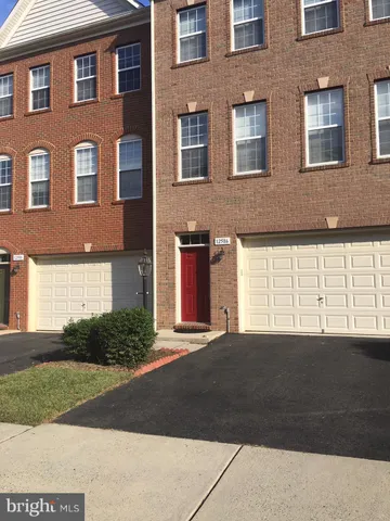 a front view of a building with a yard and a garage