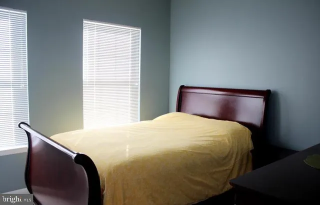a bed sitting in a bedroom next to a window