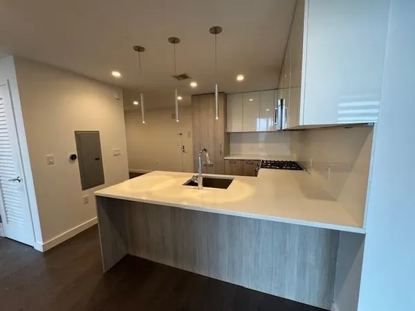 a kitchen that has a sink and a stove in it