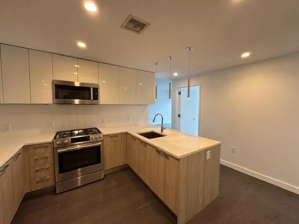 a kitchen that has a sink and a stove top oven