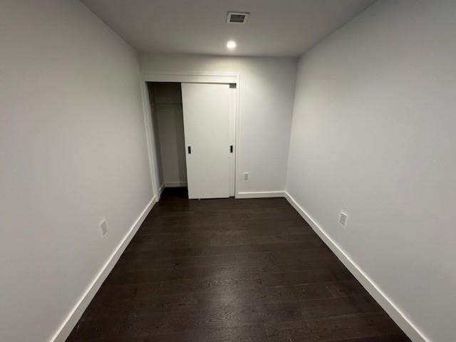 13105 40th Road, Unit 15E Queens, NY 11354 - Photo 15 of 15 an empty room with wooden floor and windows