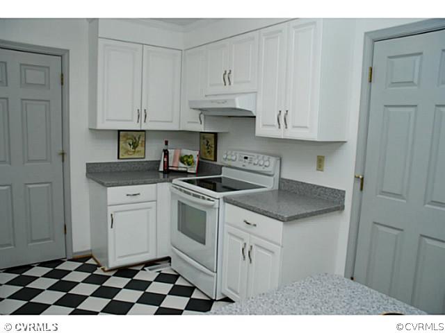 4211 Saratoga Road Richmond, VA 23235 - Photo 12 of 24 a kitchen with granite countertop white cabinets and appliances