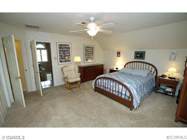 4211 Saratoga Road Richmond, VA 23235 - Photo 15 of 24 a bedroom with a bed and a chandelier