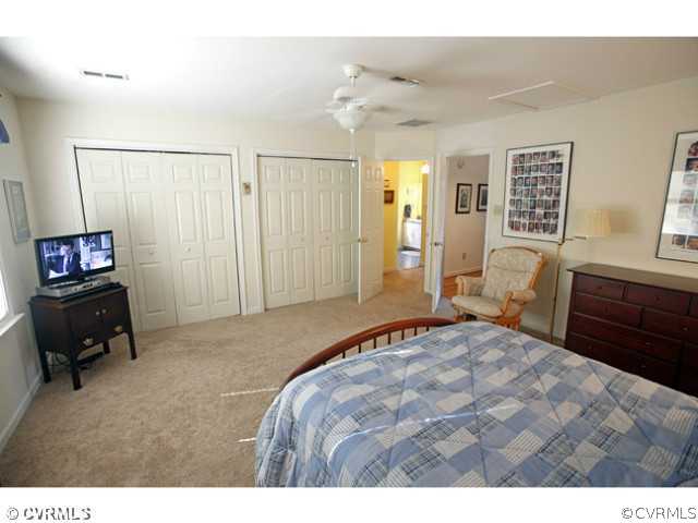 4211 Saratoga Road Richmond, VA 23235 - Photo 16 of 24 a bedroom with a bed and a television