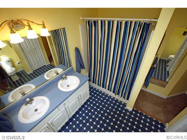 4211 Saratoga Road Richmond, VA 23235 - Photo 17 of 24 a bathroom with a sink and mirror