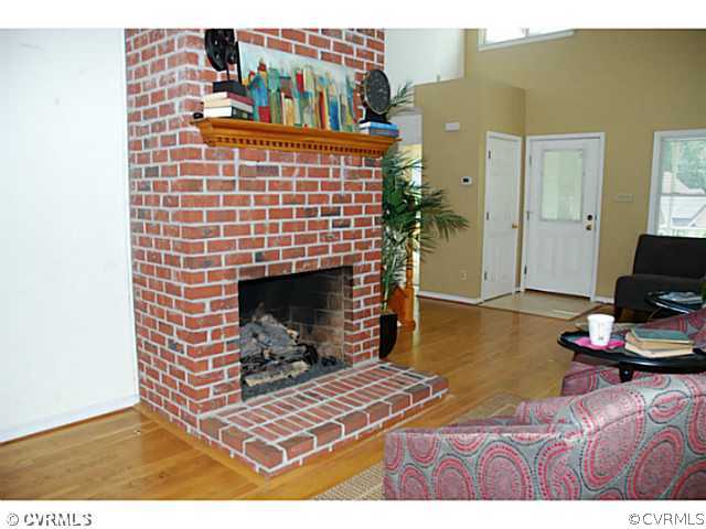 4211 Saratoga Road Richmond, VA 23235 - Photo 8 of 24 a bedroom with a bed and a fireplace