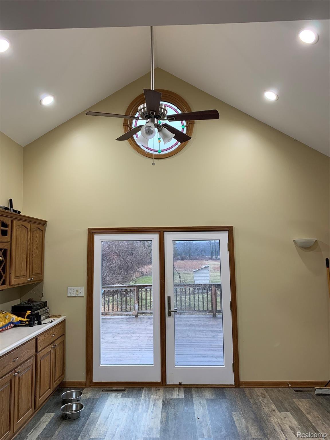7078 Fargo Road Avoca, MI 48006 - Photo 17 of 41 View from Dining room to deck. Vaulted ceiling and stain glass window up high