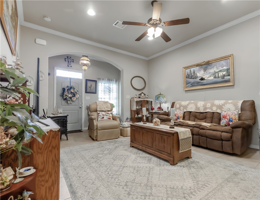 3815 Harvey Road College Station, TX 77845 - Photo 3 of 24 a living room with furniture a chandelier and a painting on the wall