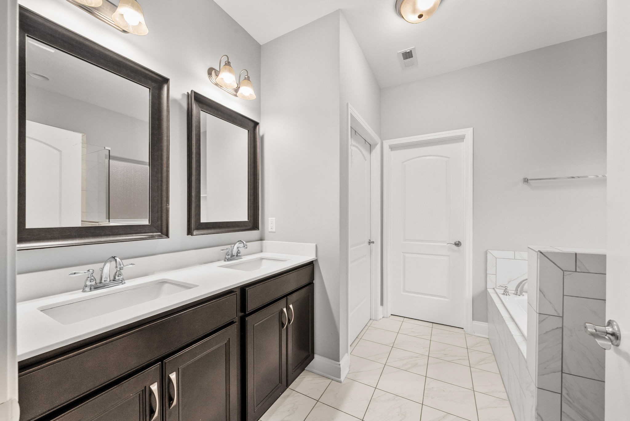 1102 Marys Place Lebanon, TN 37090 - Photo 6 of 58 a bathroom with a double vanity sink and a mirror
