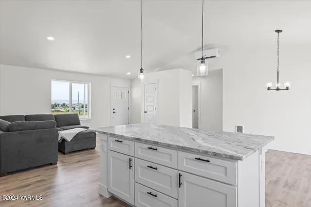 a living room with furniture and a ceiling fan