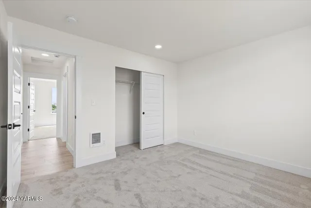 a bathroom with a granite countertop sink a toilet and shower