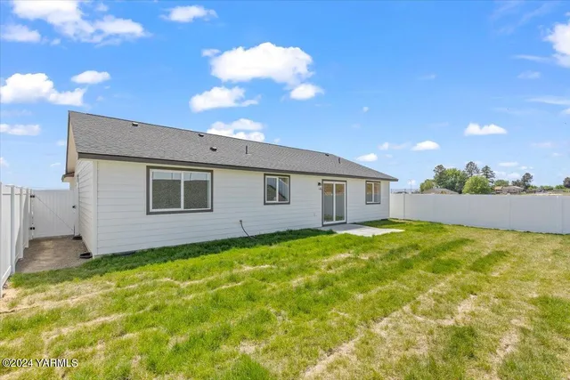 a view of a backyard with large trees