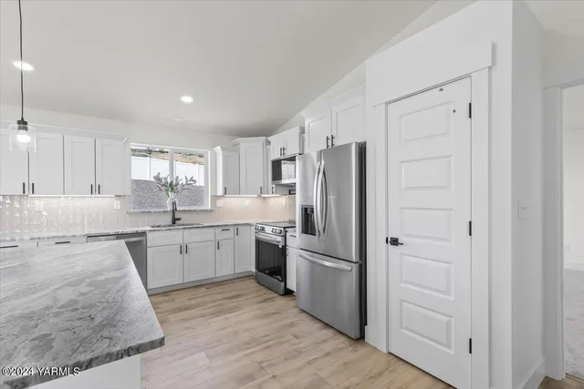a kitchen with cabinets and stainless steel appliances