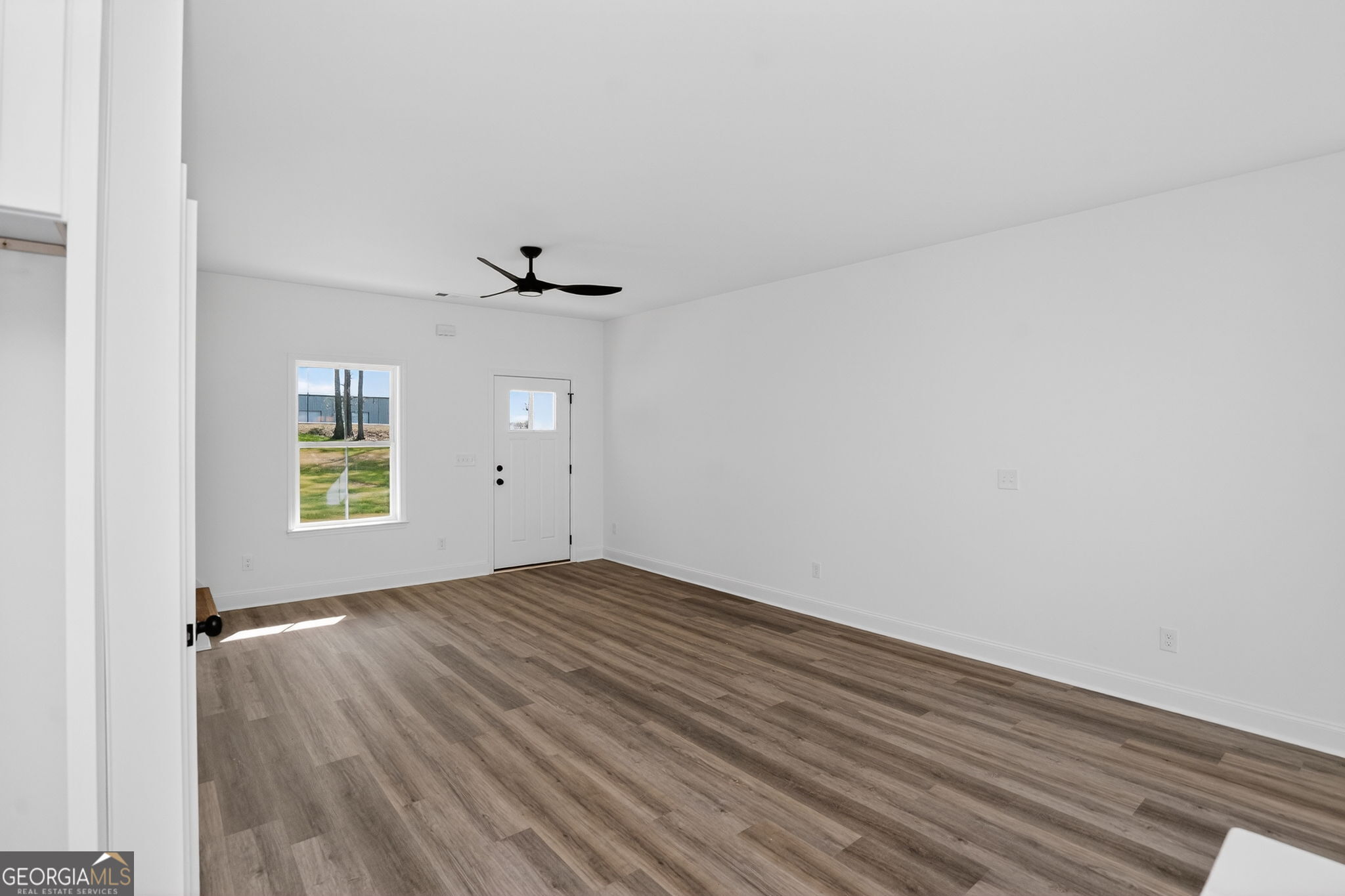 1229 Chappell Mill Road Jackson, GA 30233 - Photo 21 of 55 a view of an empty room with wooden floor and a window