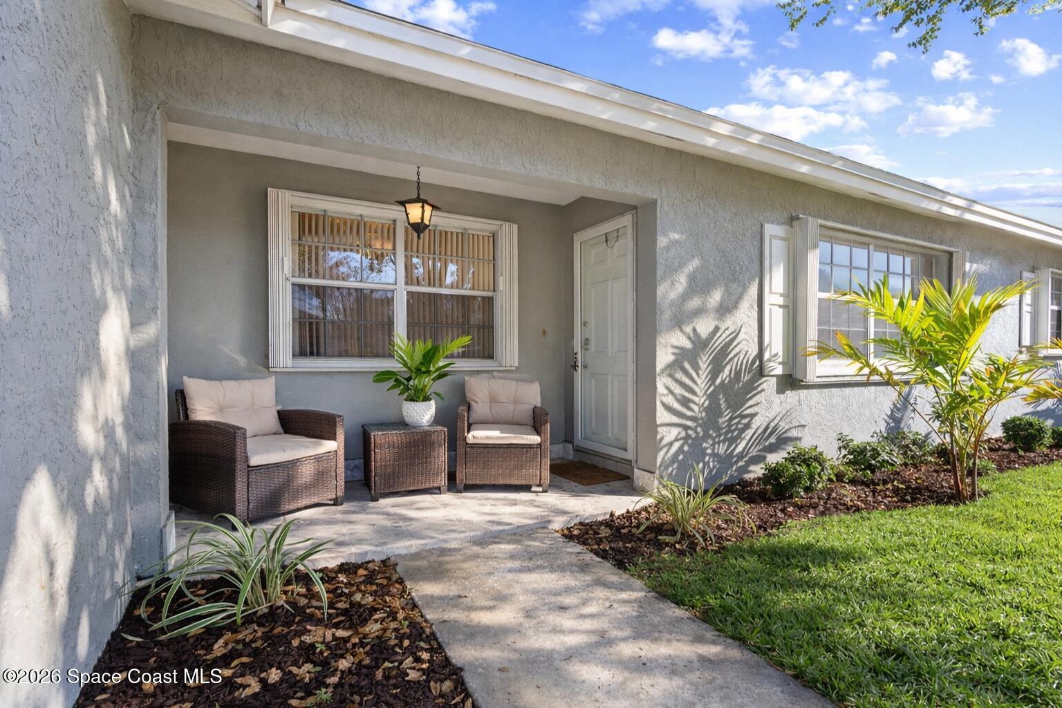 a front view of a house with outdoor seating and plants