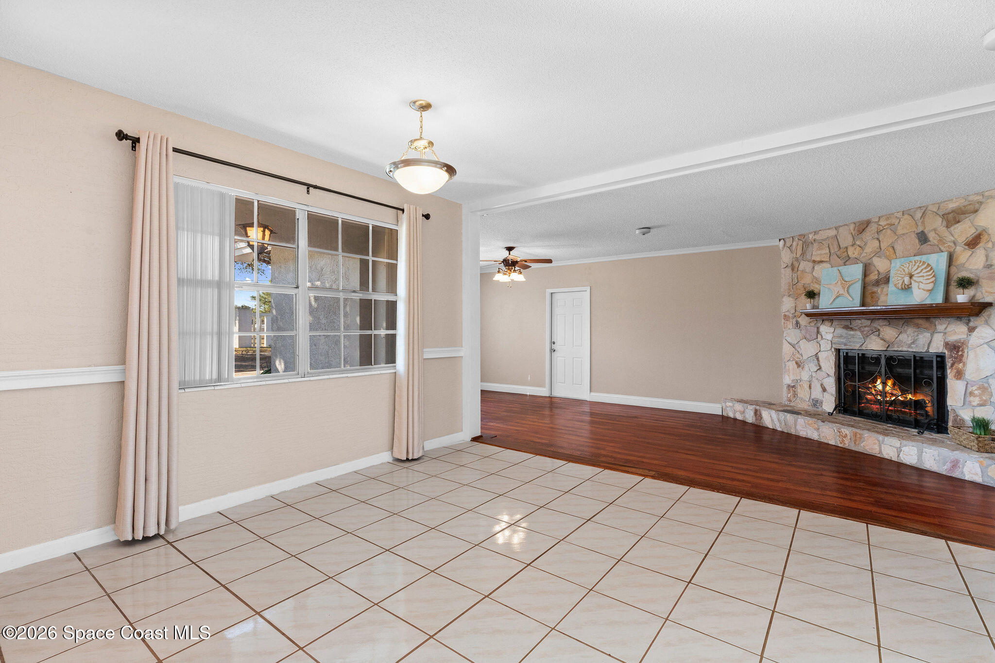 998 Kings Post Road Rockledge, FL 32955 - Photo 16 of 39 a view of an empty room with window and fire place