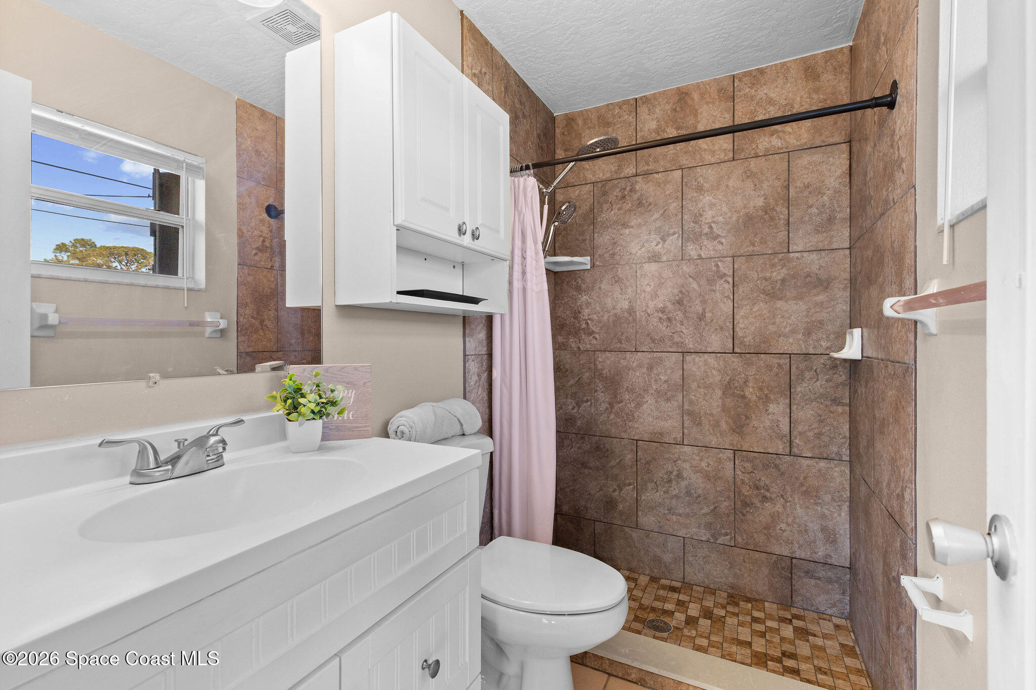 998 Kings Post Road Rockledge, FL 32955 - Photo 19 of 39 a bathroom with a sink toilet and shower