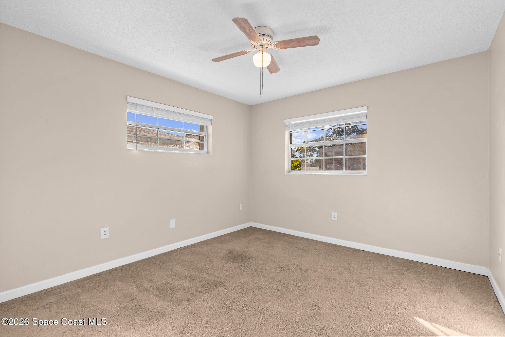 998 Kings Post Road Rockledge, FL 32955 - Photo 20 of 39 an empty room with a window and a fan