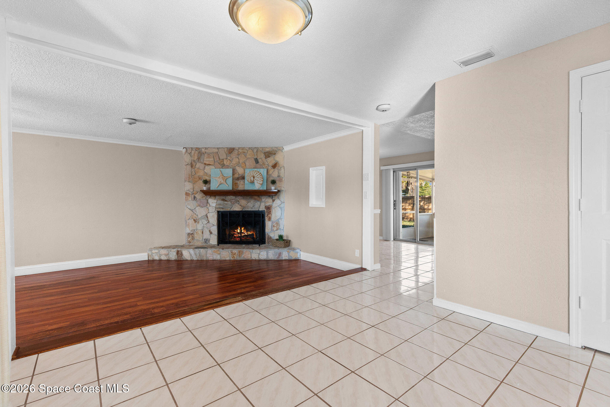 998 Kings Post Road Rockledge, FL 32955 - Photo 28 of 39 a view of a livingroom with a fireplace wooden table and chair
