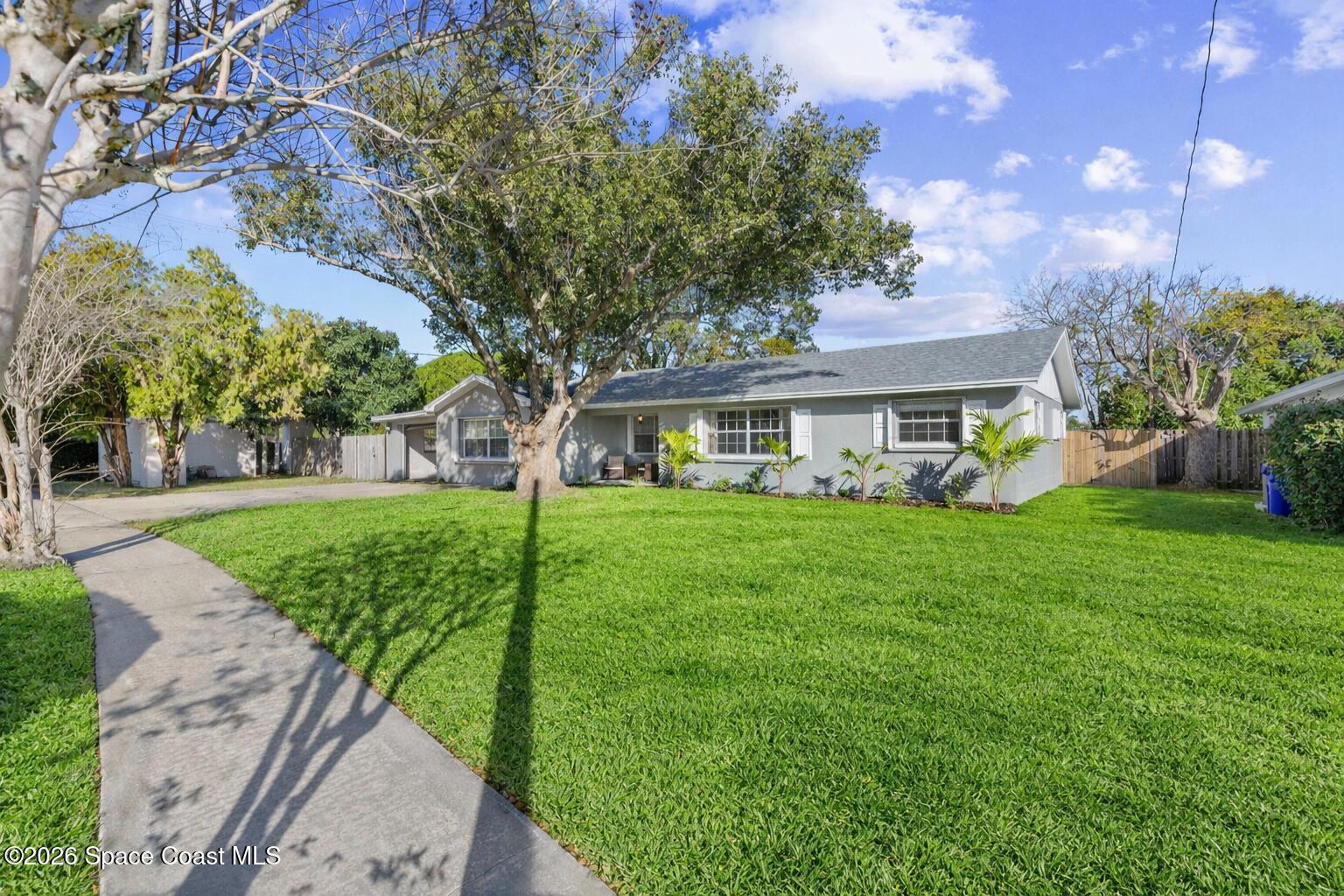 998 Kings Post Road Rockledge, FL 32955 - Photo 3 of 39 a view of house that has a yard