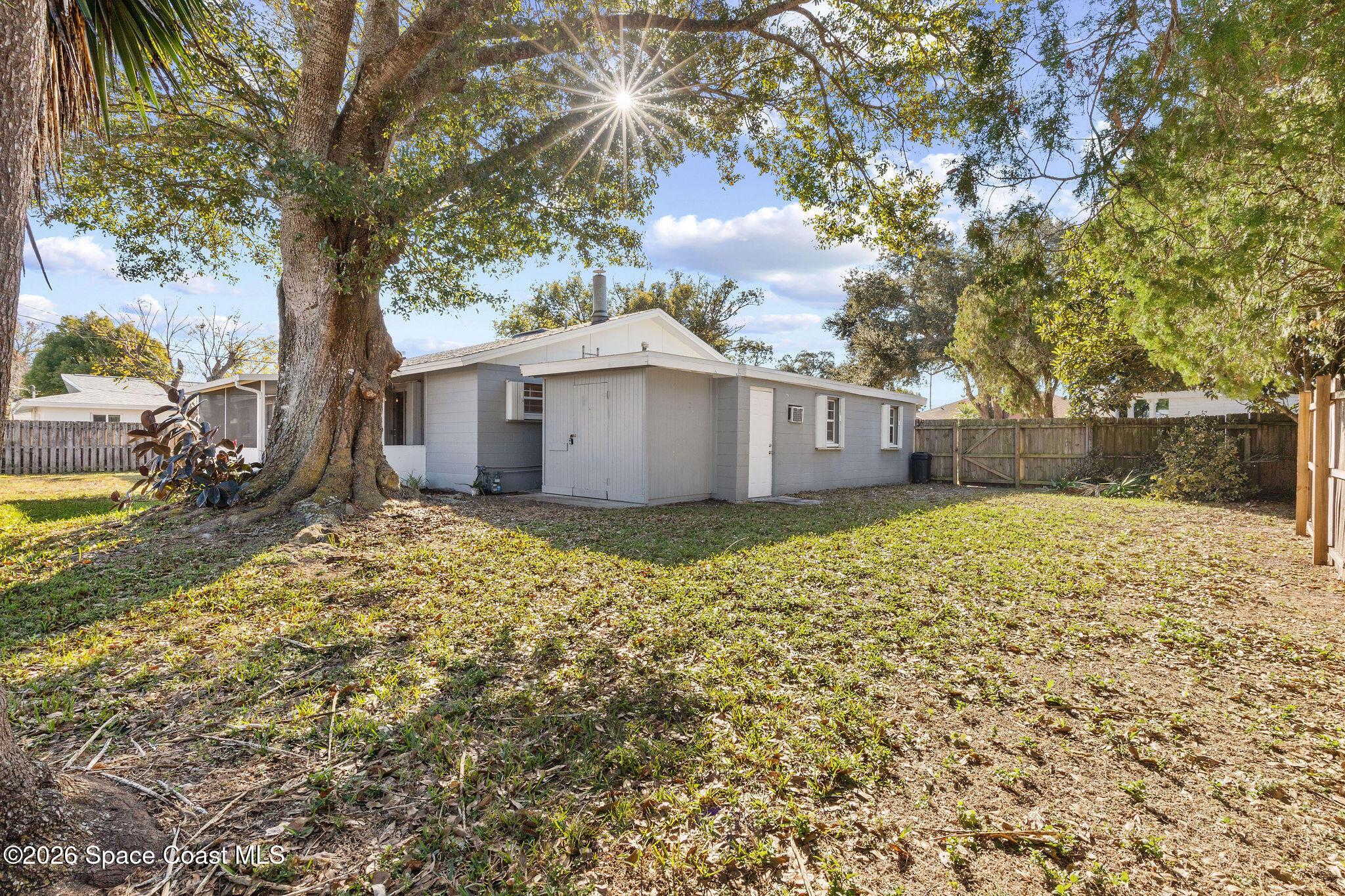 998 Kings Post Road Rockledge, FL 32955 - Photo 31 of 39 a view of a house with a large tree and a yard