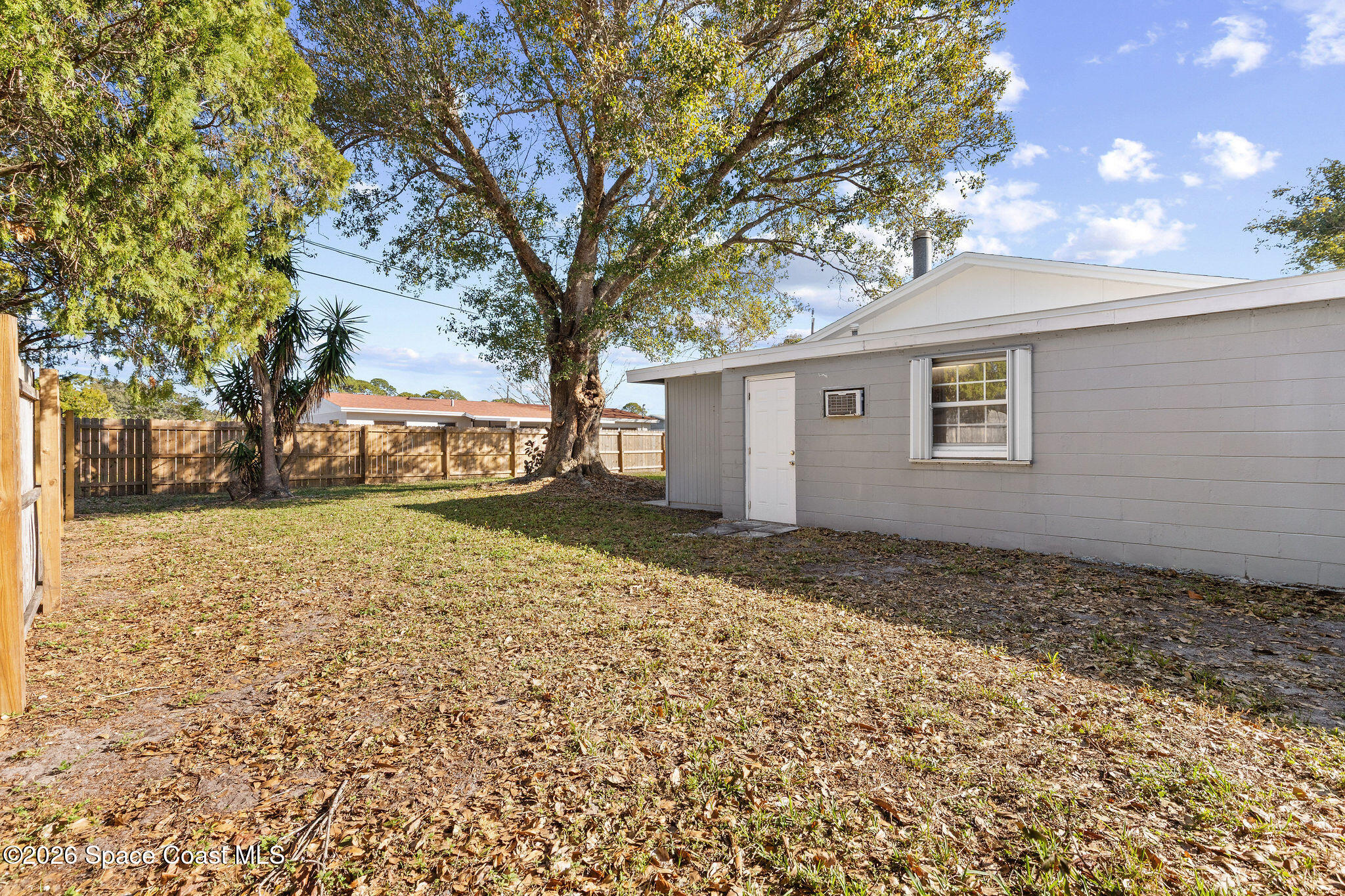 998 Kings Post Road Rockledge, FL 32955 - Photo 32 of 39 a view of a yard with a house and a large tree