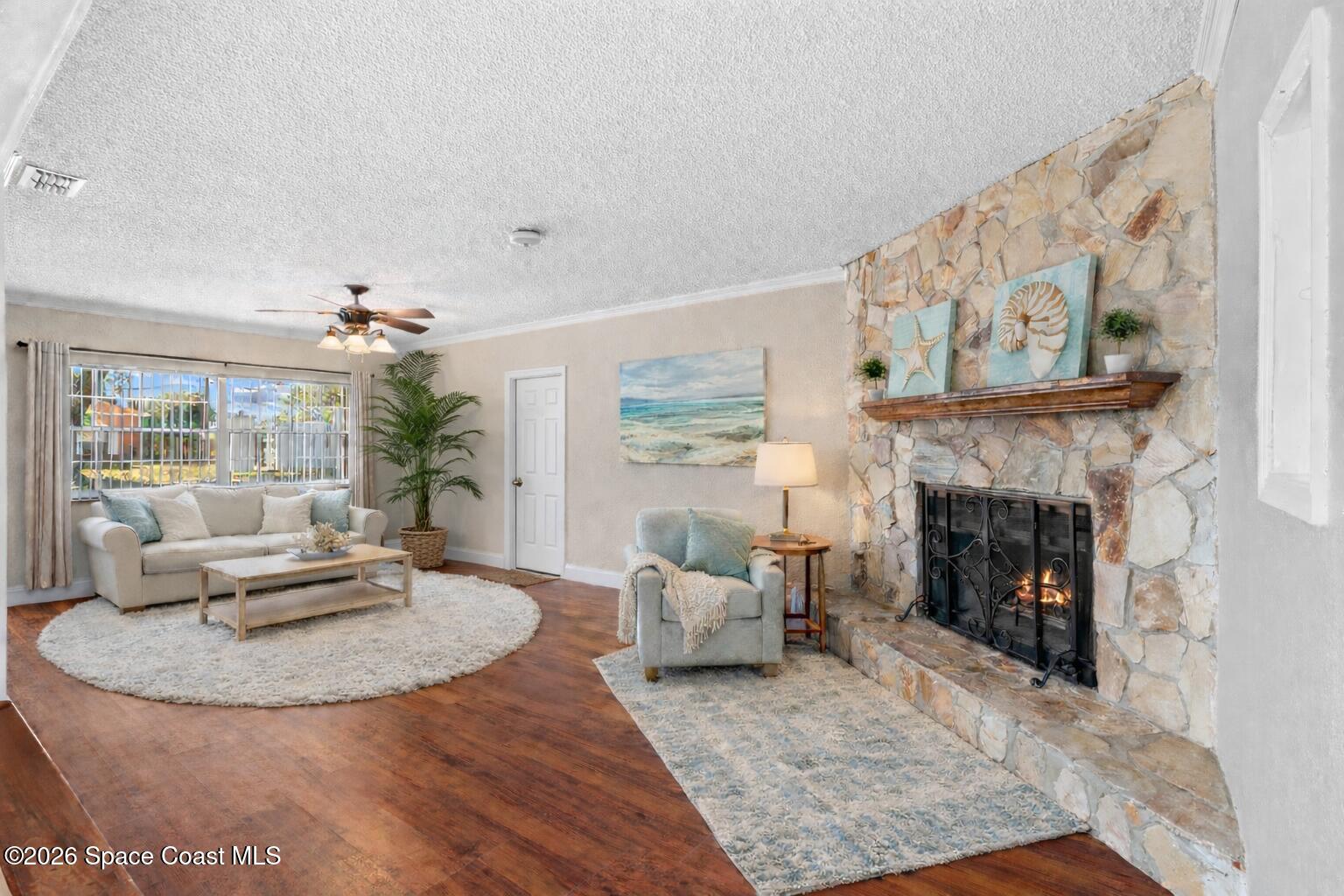 998 Kings Post Road Rockledge, FL 32955 - Photo 4 of 39 a living room with furniture and a fireplace