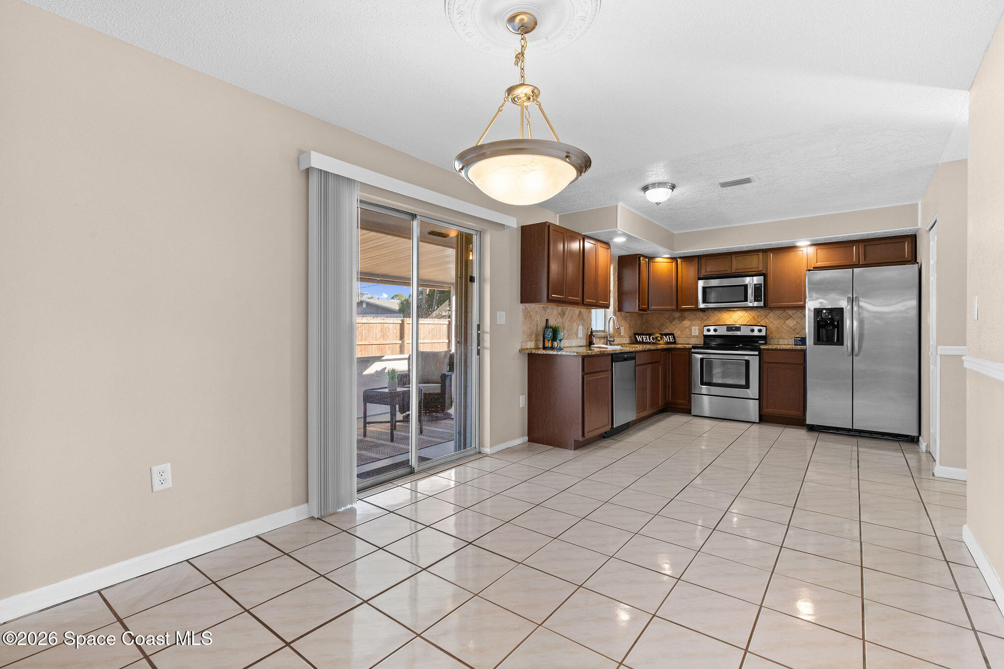 998 Kings Post Road Rockledge, FL 32955 - Photo 7 of 39 a large kitchen with cabinets and stainless steel appliances
