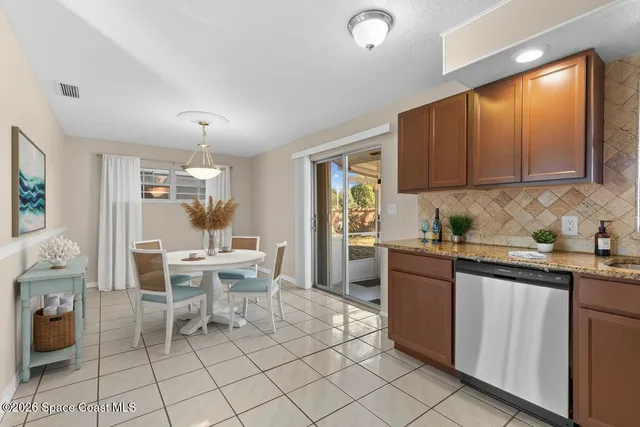a large kitchen with cabinets and stainless steel appliances