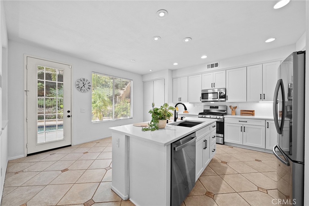 29027 Raintree Lane Saugus, CA 91390 - Photo 15 of 44 a kitchen with appliances cabinets and a sink