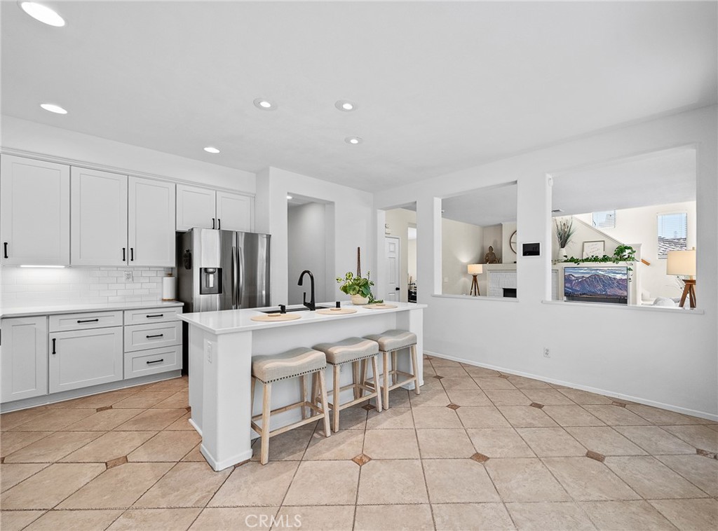 29027 Raintree Lane Saugus, CA 91390 - Photo 16 of 45 a kitchen with cabinets and chairs