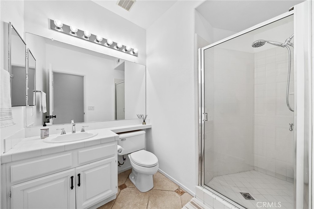29027 Raintree Lane Saugus, CA 91390 - Photo 20 of 45 a bathroom with a toilet a sink and a mirror