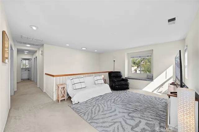 a bedroom with a bed and a couch