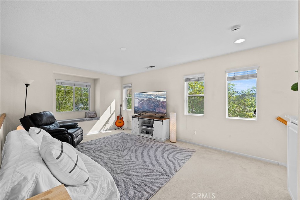 29027 Raintree Lane Saugus, CA 91390 - Photo 25 of 44 a bed room with furniture and a window