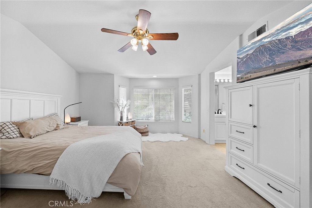 29027 Raintree Lane Saugus, CA 91390 - Photo 27 of 45 a spacious bedroom with a bed and a chandelier