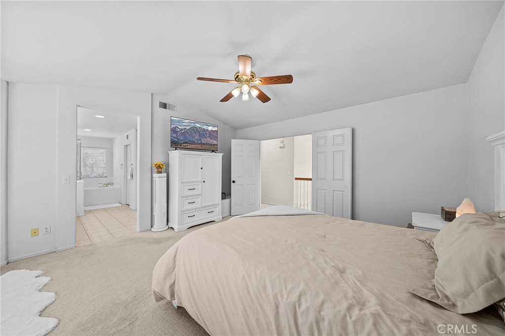 29027 Raintree Lane Saugus, CA 91390 - Photo 29 of 44 a bedroom with a bed and a chandelier