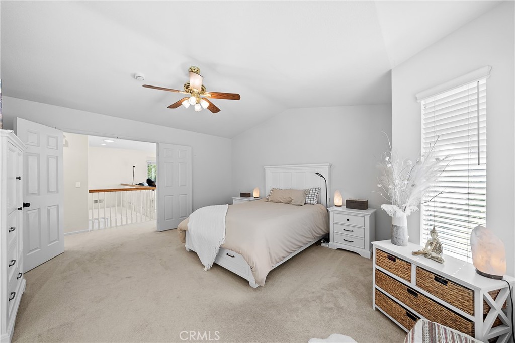 29027 Raintree Lane Saugus, CA 91390 - Photo 29 of 45 a bedroom with a bed and a chandelier