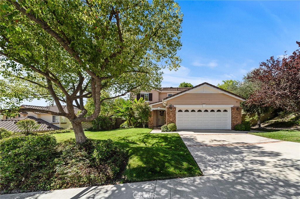 29027 Raintree Lane Saugus, CA 91390 - Photo 3 of 45 a front view of a house with a yard