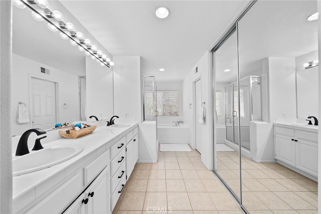 29027 Raintree Lane Saugus, CA 91390 - Photo 31 of 44 a bathroom with a sink a tub and shower