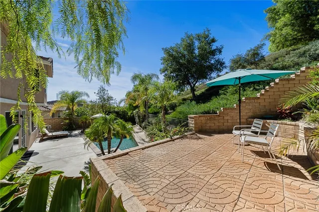 a view of a backyard with plants and a patio